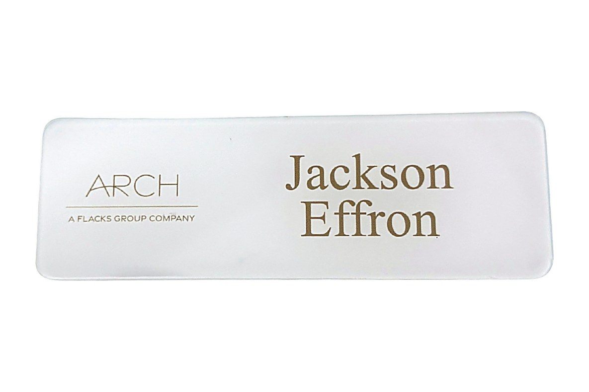 Frosted clear acrylic name tag with a gold logo and a two-line name
