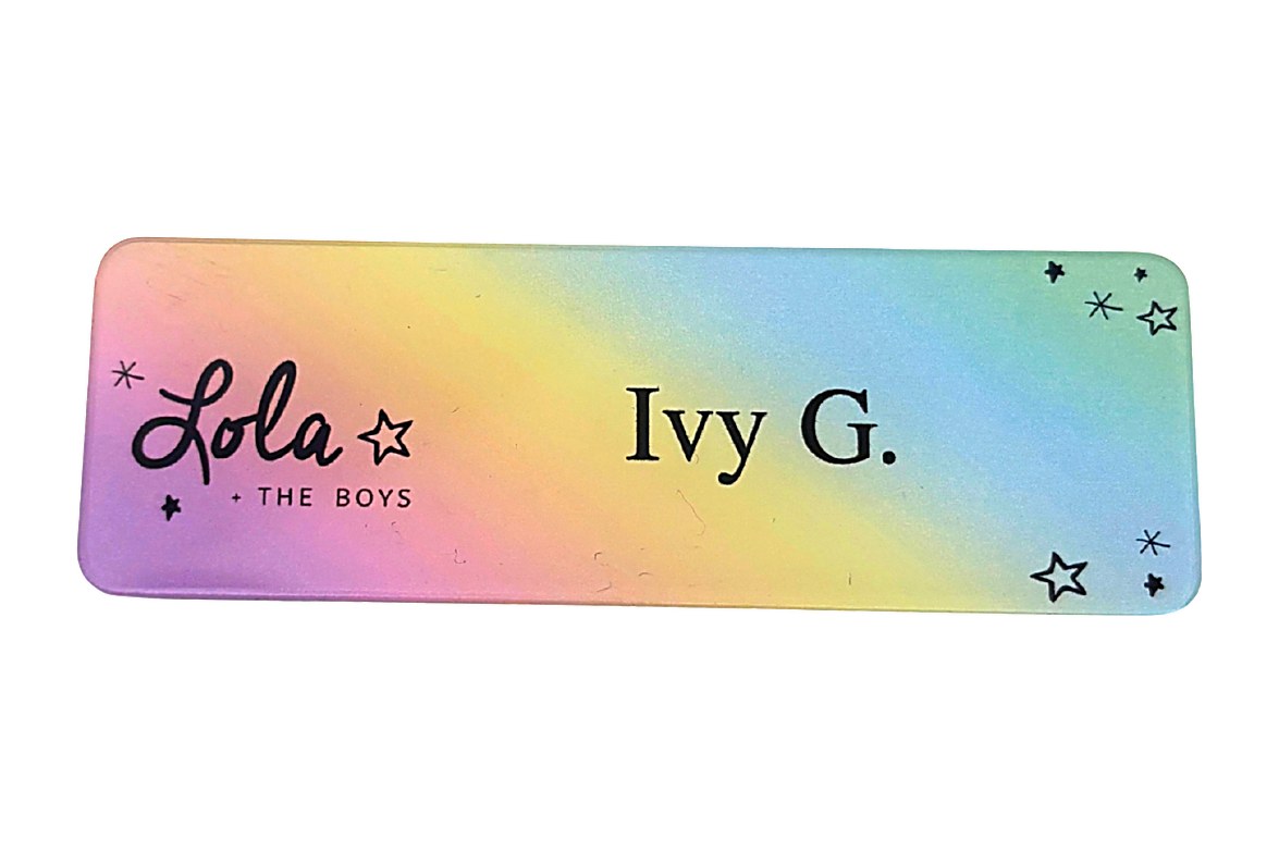 Clear acrylic name tag with a pastel gradient print, script logo and stars