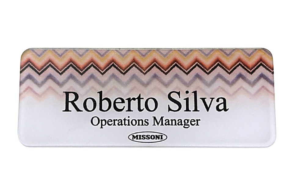 Clear acrylic name tag with a printed zigzag pattern, name, title and logo