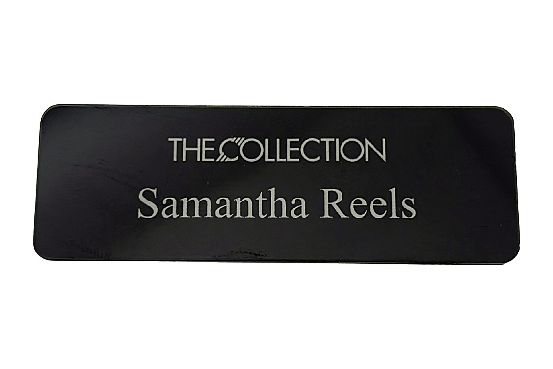 Black clear acrylic name tag with white printed name and property