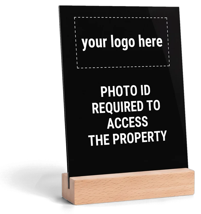 Black acrylic tabletop sign with white print, wood base on the bottom