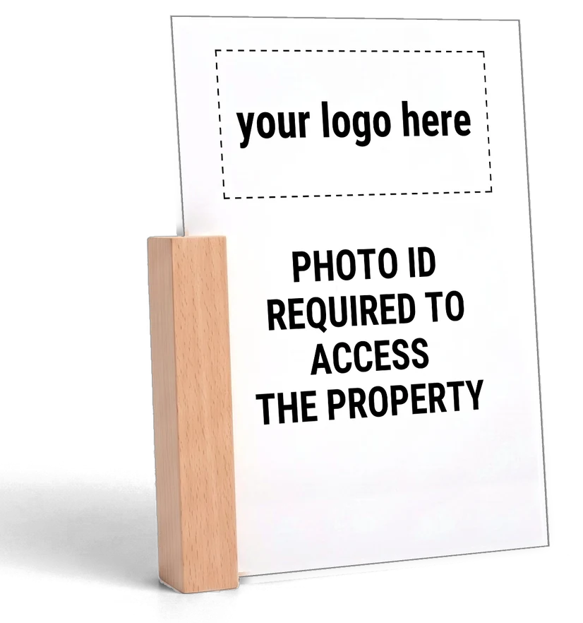 White acrylic tabletop sign with black print, wood base on the side